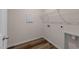 Laundry room with wood-look flooring and white wire shelving at 1401 Justice Union Ct, Raleigh, NC 27604