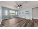 Bright living room with wood flooring, lots of light, a ceiling fan, and a TV mount on the wall at 1401 Justice Union Ct, Raleigh, NC 27604