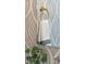 Close-up of a stylish powder room mirror with a decorative towel and foliage detail at 1408 Sawyer Rd # 103, Raleigh, NC 27610