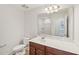 Bathroom featuring a mirror above a vanity and a white toilet, creating a functional and clean space at 1534 Glenwater Dr, Cary, NC 27519