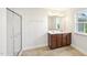 Bathroom featuring double vanity, a large mirror, and a glass enclosed shower at 1534 Glenwater Dr, Cary, NC 27519