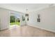 Open living space with light wood floors, large sliding doors to the patio, and ample natural light at 1534 Glenwater Dr, Cary, NC 27519