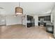 Open-concept living space featuring wood floors, a ceiling fan, and views into the modern kitchen at 1534 Glenwater Dr, Cary, NC 27519