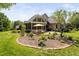 A view of the backyard featuring mature trees, patio, and landscaping at 154 Sicily Dr, Clayton, NC 27527