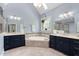 Light-filled bathroom featuring a soaking tub, double vanities, and tile flooring at 154 Sicily Dr, Clayton, NC 27527