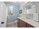 Well-lit bathroom with a wood vanity, a large mirror, and a neutral color palette at 154 Sicily Dr, Clayton, NC 27527