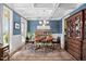 Stylish dining room with coffered ceilings, blue accent wall, and a large oriental rug at 154 Sicily Dr, Clayton, NC 27527