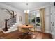 Charming dining area featuring hardwood floors, a stylish light fixture, and a bright window at 154 Sicily Dr, Clayton, NC 27527