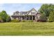 Charming two-story brick home with a well-manicured lawn and inviting front porch at 154 Sicily Dr, Clayton, NC 27527