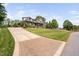 Beautifully landscaped front yard with a long driveway leading up to a grand two-story home at 154 Sicily Dr, Clayton, NC 27527