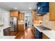 Bright kitchen with stainless steel appliances and wooden cabinets featuring hardwood floors and an open floor plan at 154 Sicily Dr, Clayton, NC 27527