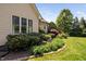 Lush landscaping, including manicured bushes and flowering plants, surrounds the home at 154 Sicily Dr, Clayton, NC 27527