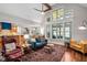 Open concept living area with hardwood floors, large windows, and comfortable seating at 154 Sicily Dr, Clayton, NC 27527