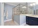 Modern bathroom with a glass-enclosed shower and blue accent wall at 154 Sicily Dr, Clayton, NC 27527