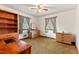 This cozy bedroom features a ceiling fan, two windows, and vintage built-in shelving at 1593 E Washington Ave, Creedmoor, NC 27522