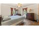 Bedroom includes a ceiling fan, two windows and wood dresser set at 1593 E Washington Ave, Creedmoor, NC 27522