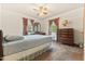 Bedroom includes a ceiling fan, two windows and wood dresser set at 1593 E Washington Ave, Creedmoor, NC 27522
