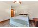 Bedroom with a bed, wood dresser, ceiling fan, and natural light at 1593 E Washington Ave, Creedmoor, NC 27522