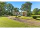 Charming home with a brick accent, a gravel driveway, and a well-maintained lawn at 1593 E Washington Ave, Creedmoor, NC 27522