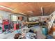 Organized garage interior featuring tools, boat, and ample workspace for various projects at 1593 E Washington Ave, Creedmoor, NC 27522