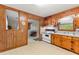 Kitchen includes white appliances, a double sink, and a window with natural light at 1593 E Washington Ave, Creedmoor, NC 27522