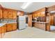 Kitchen features wood cabinets, ample counter space, and white appliances at 1593 E Washington Ave, Creedmoor, NC 27522