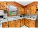 Functional kitchen showcasing ample wood cabinetry and laminate countertops at 1593 E Washington Ave, Creedmoor, NC 27522