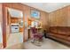 Living room area showcasing wood paneling and a view into the adjacent kitchen at 1593 E Washington Ave, Creedmoor, NC 27522