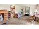 Cozy living room showcasing vintage furniture and a large window for natural light at 1593 E Washington Ave, Creedmoor, NC 27522