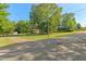 This charming home has mature shade trees and a lush green lawn at 1593 E Washington Ave, Creedmoor, NC 27522