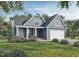 Charming blue two-story home featuring a well-manicured lawn, covered porch, and attached garage, inviting and picturesque at 161 Wheeler Ct, Clayton, NC 27527