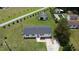 Aerial view showing the home, garage, and a neighbor's in-ground pool on the large grassy property at 1676 Richardson Bass Rd, Kenly, NC 27542