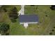 An aerial shot showing the back deck of the house, surrounding grass, and shady trees at 1676 Richardson Bass Rd, Kenly, NC 27542