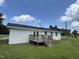 Charming home with a wooden deck surrounded by a lush green backyard at 1676 Richardson Bass Rd, Kenly, NC 27542