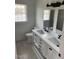 Bright bathroom featuring a double sink vanity with black hardware and framed mirrors at 1676 Richardson Bass Rd, Kenly, NC 27542