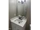 Modern bathroom features a white vanity with a sleek countertop and a lighted mirror at 1676 Richardson Bass Rd, Kenly, NC 27542