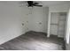 Bright bedroom with light gray floors, closet and ceiling fan at 1676 Richardson Bass Rd, Kenly, NC 27542