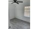 Cozy bedroom with a ceiling fan, a window bringing in natural light, and light gray flooring at 1676 Richardson Bass Rd, Kenly, NC 27542