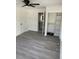 Bright bedroom with light gray floors, closet and adjacent bathroom at 1676 Richardson Bass Rd, Kenly, NC 27542