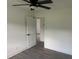 Bedroom with gray floors, ceiling fan, white door and white trim at 1676 Richardson Bass Rd, Kenly, NC 27542