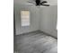 Light-filled bedroom with two windows, light gray flooring, and a ceiling fan at 1676 Richardson Bass Rd, Kenly, NC 27542