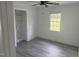 Bright bedroom with a window offering backyard view, a closet, and light gray flooring at 1676 Richardson Bass Rd, Kenly, NC 27542