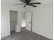 Inviting bedroom featuring a built-in closet with shelving and light gray flooring at 1676 Richardson Bass Rd, Kenly, NC 27542