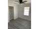 Bedroom featuring a window, shelving in the closet, and light gray flooring at 1676 Richardson Bass Rd, Kenly, NC 27542