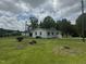 Charming white home with a well-maintained lawn and inviting curb appeal at 1676 Richardson Bass Rd, Kenly, NC 27542