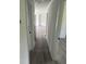 Hallway features gray laminate flooring and white trim at 1676 Richardson Bass Rd, Kenly, NC 27542