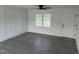 Stylish living room with gray wood-look floors, decorative wall paneling, natural light, and a modern ceiling fan at 1676 Richardson Bass Rd, Kenly, NC 27542