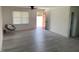 Bright and airy living room featuring wood-look flooring, neutral walls, and a view of the front yard through a window at 1676 Richardson Bass Rd, Kenly, NC 27542