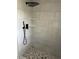Modern walk-in shower showcasing light tile and a stylish rain shower head at 1676 Richardson Bass Rd, Kenly, NC 27542