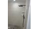 Stylish shower with pebble floor and large tile walls, accented with a modern shower head at 1676 Richardson Bass Rd, Kenly, NC 27542